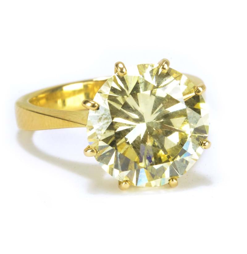 An impressive 18ct yellow gold and fancy light yellow brilliant cut diamond solitaire ring.
