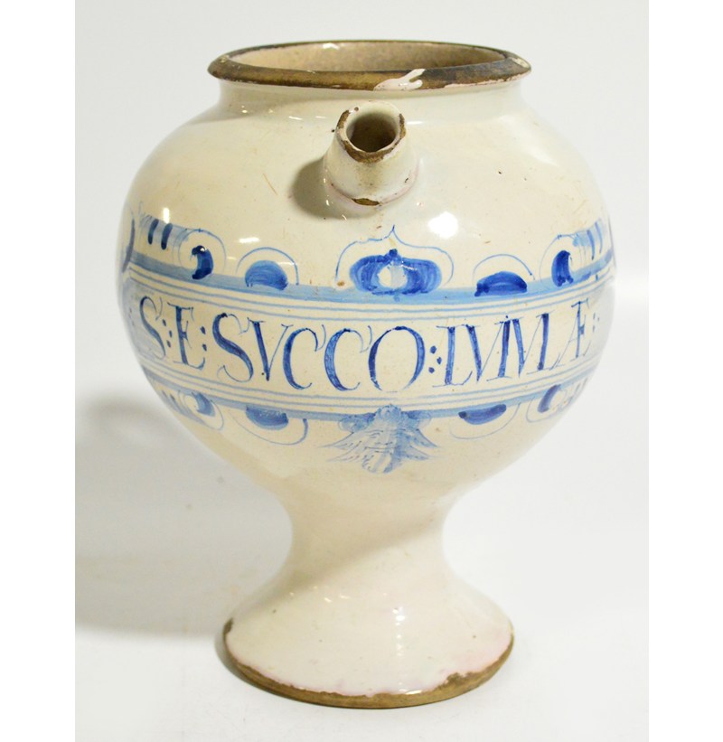 A 17th century English Delft drug jar, man smoking pipe design, inscribed "S:E:SVCO:LVIVLAE:2".