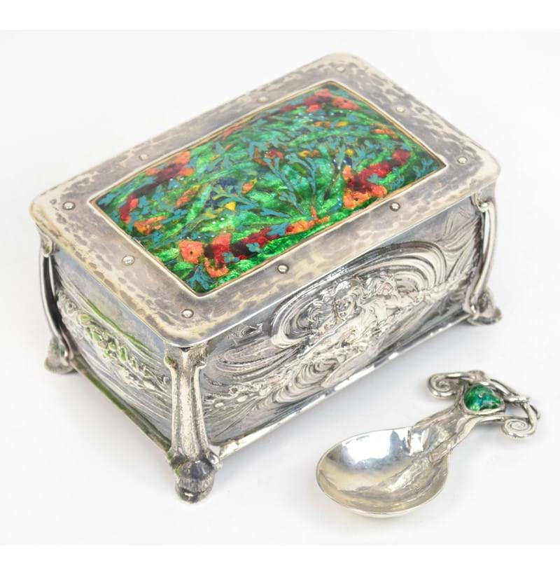 Ramsden & Carr; a fine Arts and Crafts silver and enamel decorated rounded rectangular tea canister and cover, and an enamelled caddy spoon.