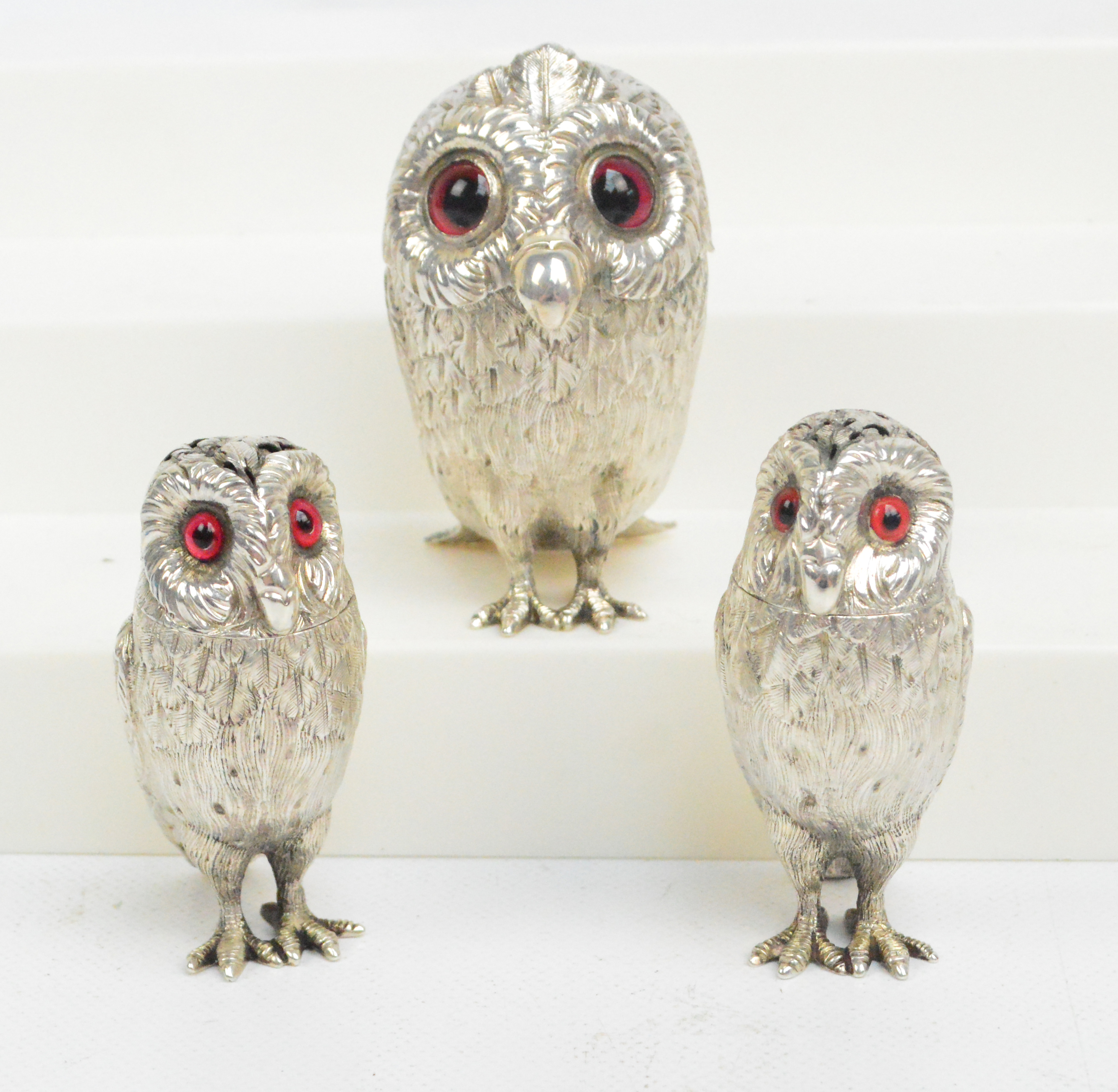 A rare leather cased Victorian hallmarked silver three piece cruet set, each piece in the form of an owl, Richards & Brown, London 1865 and 1867.