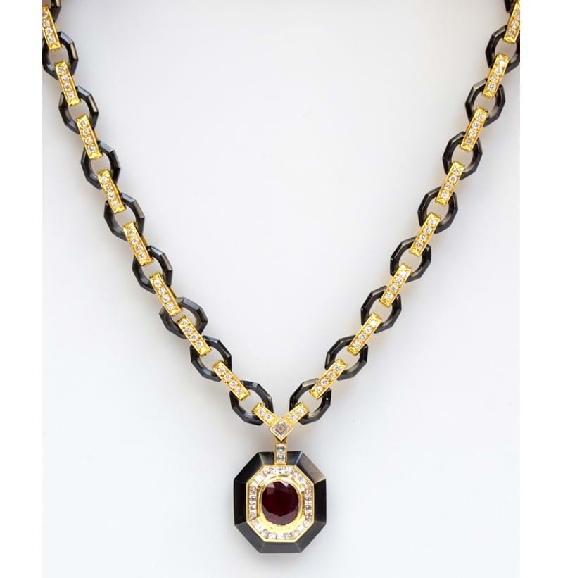 VAN CLEEF & ARPELS; an 18ct gold 'black platinum' ruby and diamond necklace.