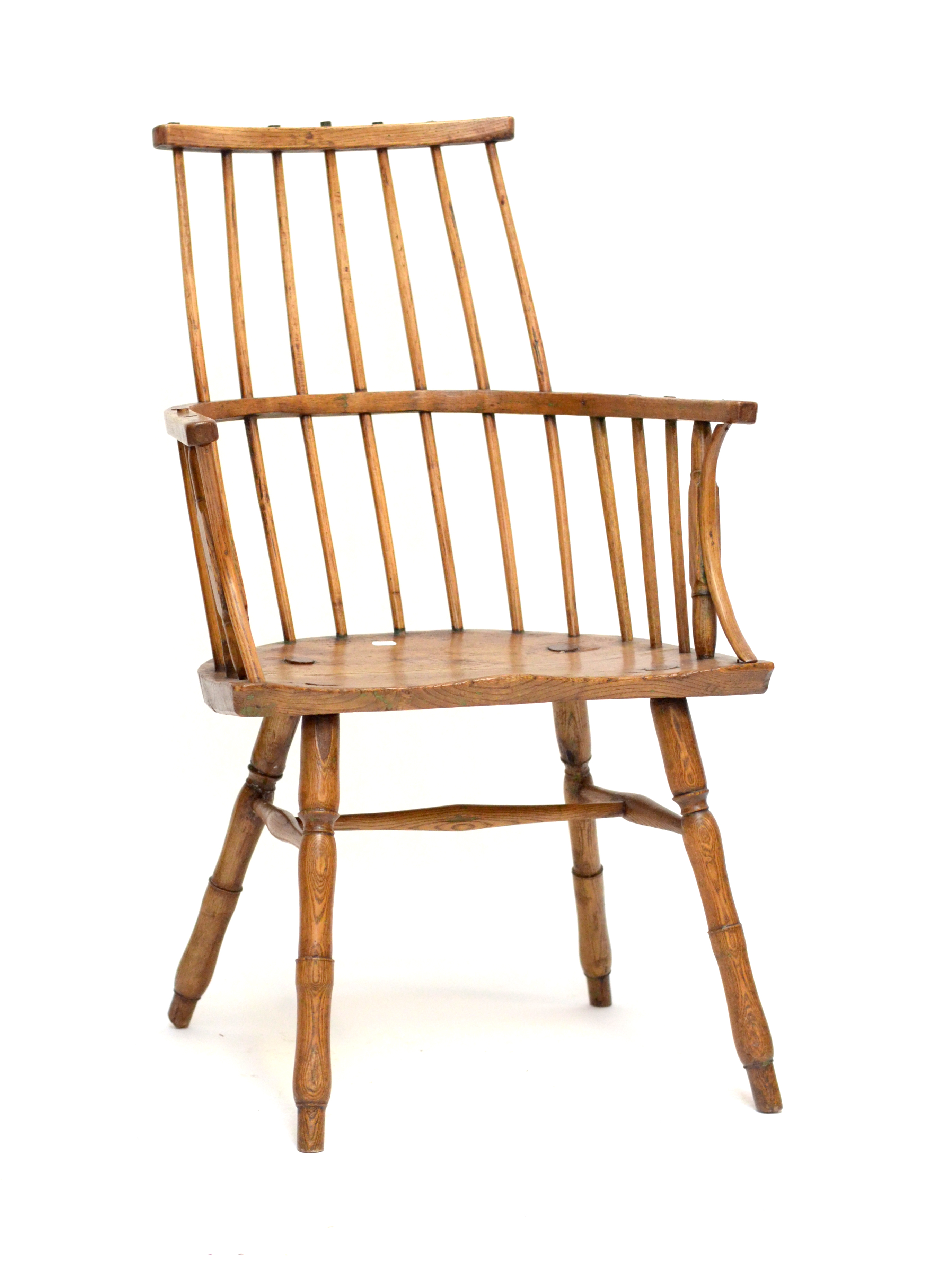 An early 19th century primitive Welsh comb stick back elbow chair.