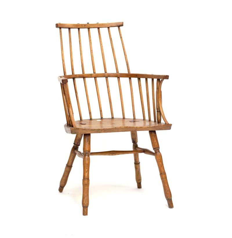 An early 19th century primitive Welsh comb stick back elbow chair.