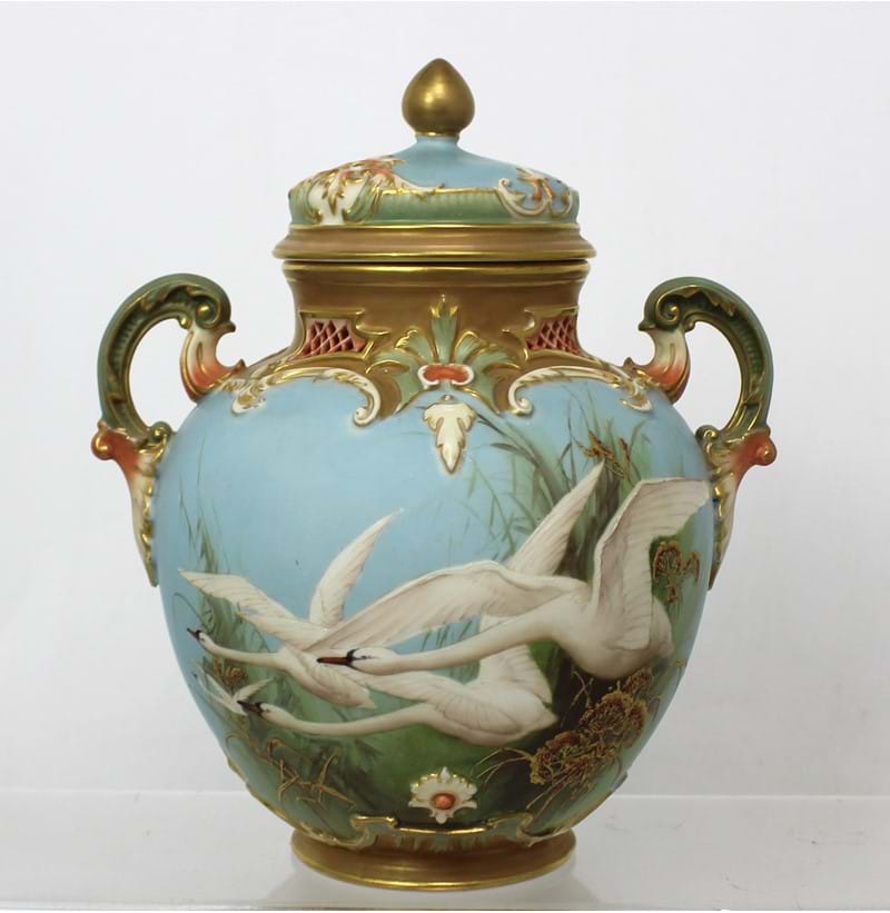 Royal Worcester; a fine twin-handled ovoid vase with cover, painted with swans, signed C Baldwyn.