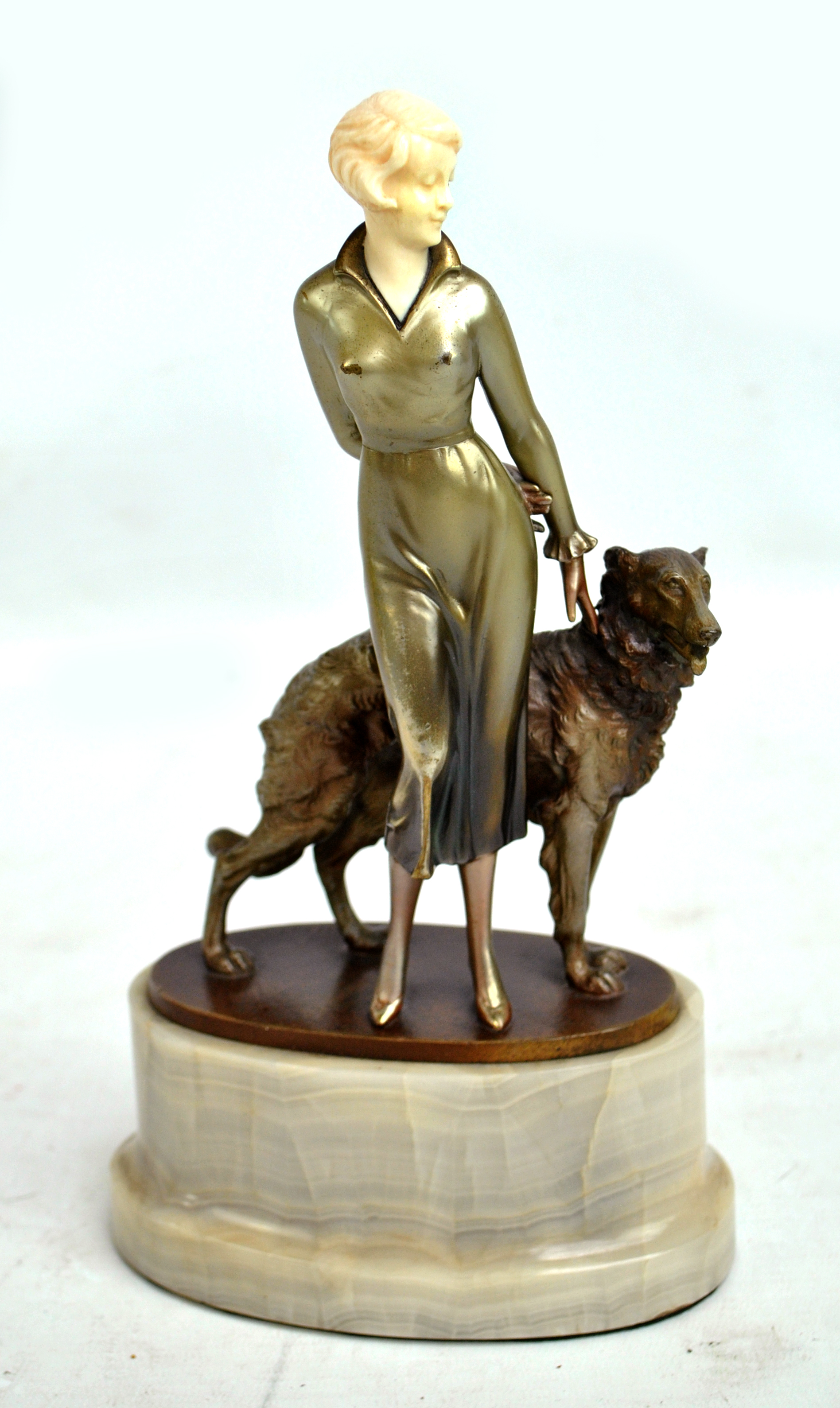 JOSEF LORENZL (AUSTRIAN 1892-1950); an Art Deco painted bronze and ivory figure of woman with a Borzoi.