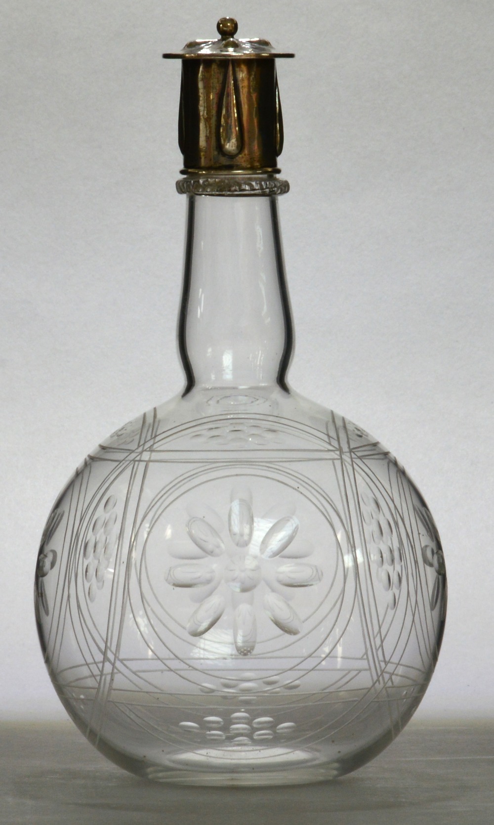 JAMES POWELL WHITEFRIARS; a clear glass bottle form decanter with silver cap designed by Harry Powell.
