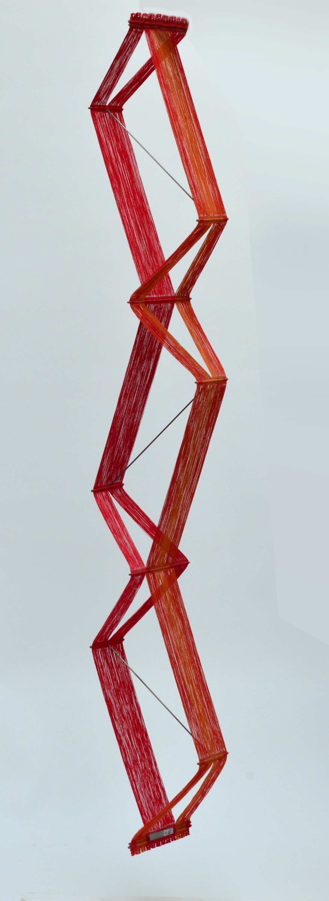 PETER COLLINGWOOD (1922-2008); a red and orange three dimensional macro gauze hanging.