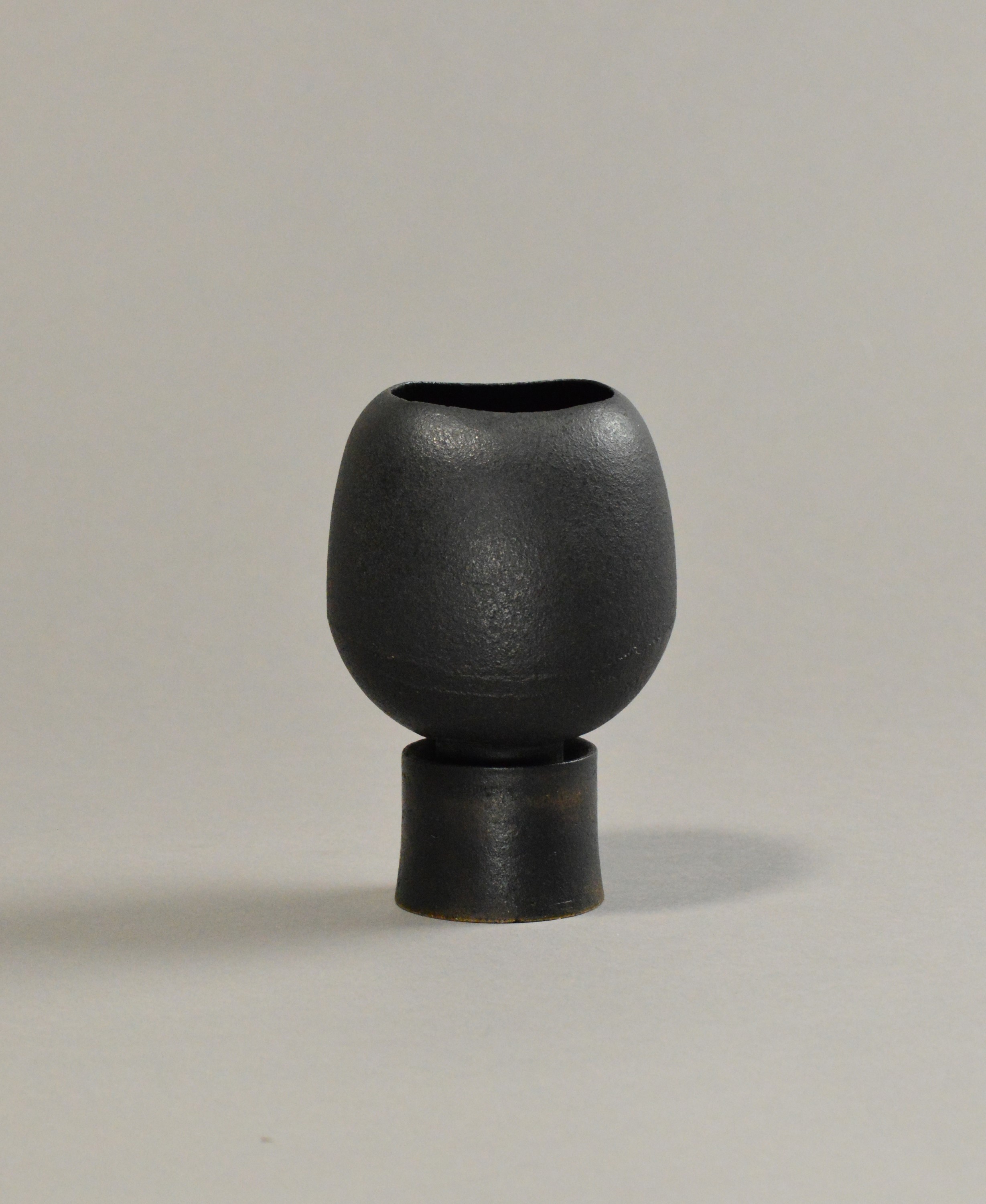 HANS COPER (1920-1981); a stoneware elliptical flower holder on drum base. 