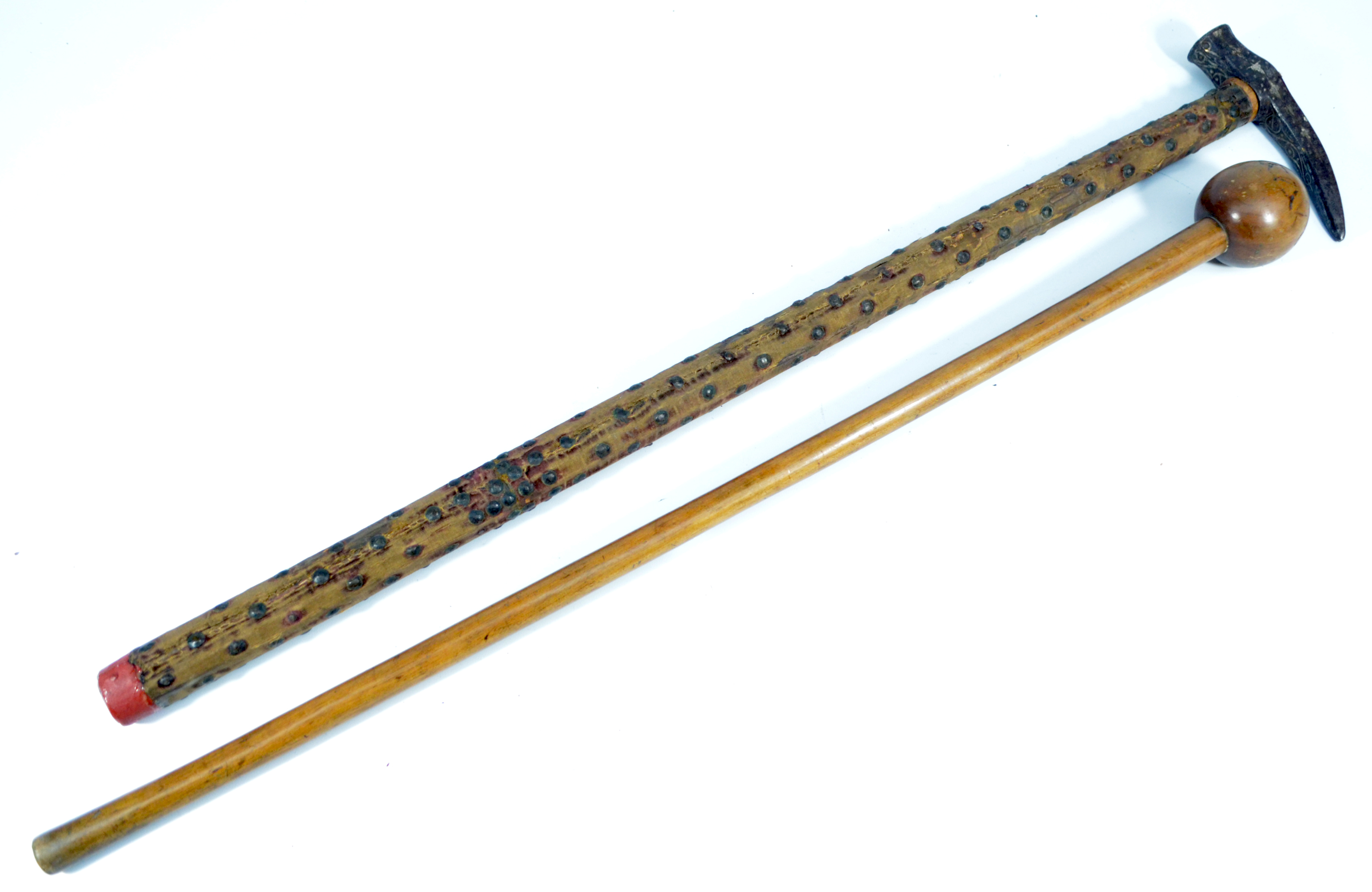 An engraved war pick with stud decorated shaft and a knobkerrie.