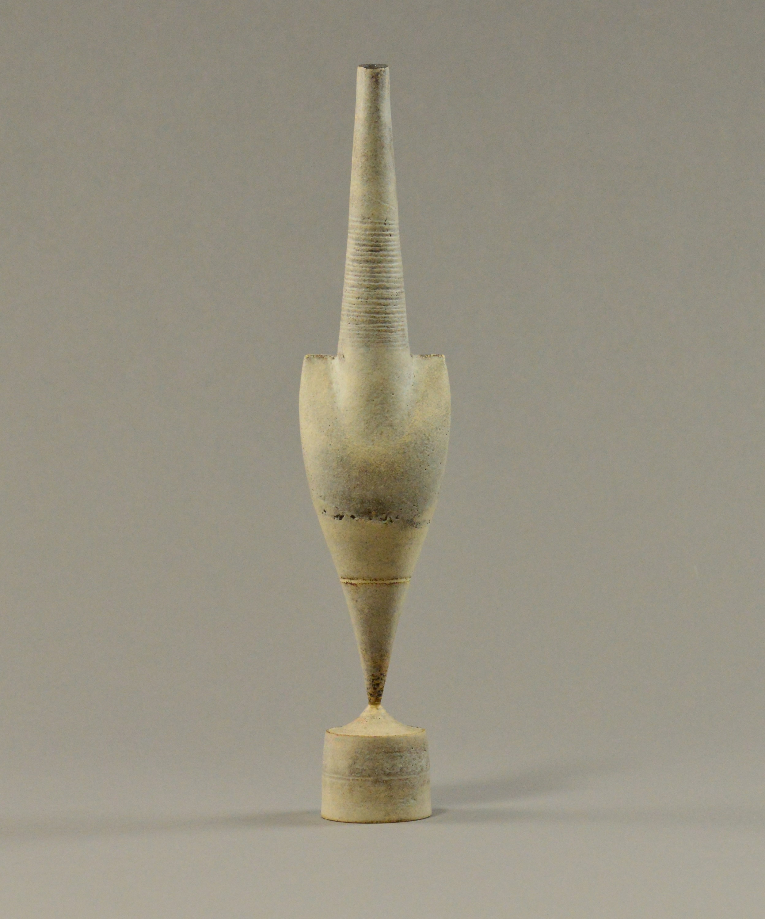 HANS COPER (1920-1981); a stoneware cycladic arrow form pinned to drum base.